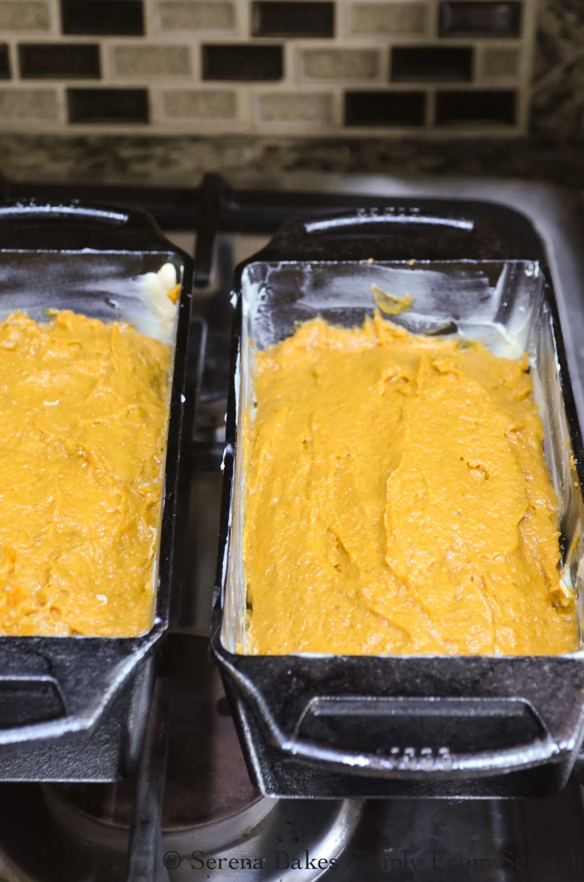 2 Buttered bread pans with Pumpkin Bread batter divided equally between pans.