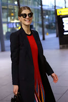 Rosamund Pike in Red Dress at London’s Heathrow Airport