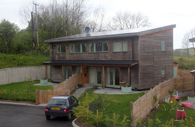 A pair of two-bedroomed semi-detached houses. All the homes have solar roofs.