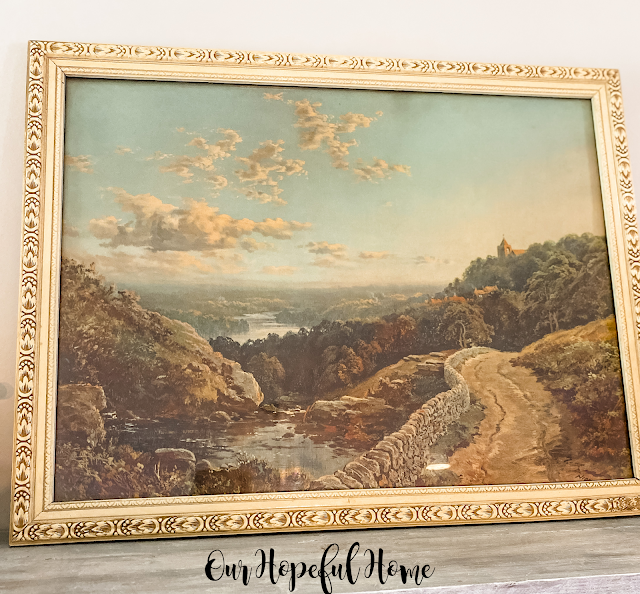 large vintage landscape painting in frame
