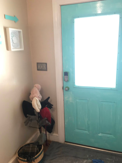 Update a boring entry way with a bright door and hand painted accent wall using a sponge! 