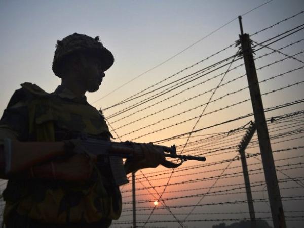 A BSF jawan patrols along the fence at the India-Pakistan border in R.S. Pura sector in Jammu and Kashmir. File photo