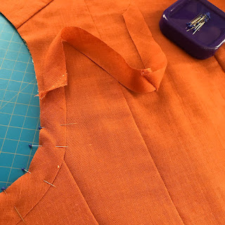 pieces of orange fabric pinned to create a bodice