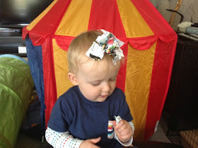 picture of baby sitting with scraps of paper on their head