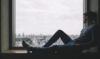 Man-sitting-looking-out-the-window