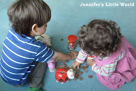 Children putting money in money boxes