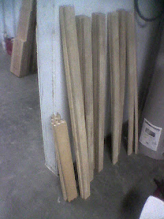 leaning against a wall of my workshop are 18 boards reclaimed from a broken futon frame. The nearest 6 boards were used to build a functional rough design.