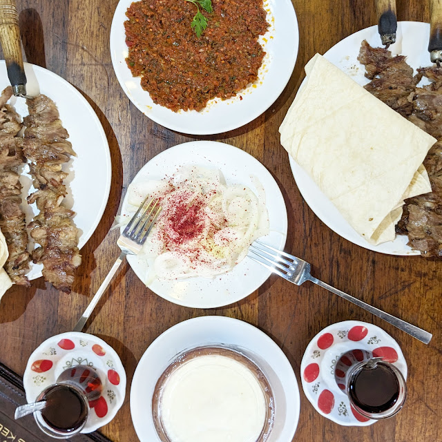 A flat lay of Grilled lamb, lavash bread and turkish tea at Sehzade Cag Kebap in Istanbul, Turkey. The city is one of the best travel destinations for foodies