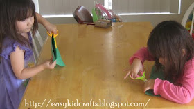 Twins using scissors for their Lantern