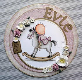 Circular pink baby girl card with baby on rocking horse (image from LOTV)