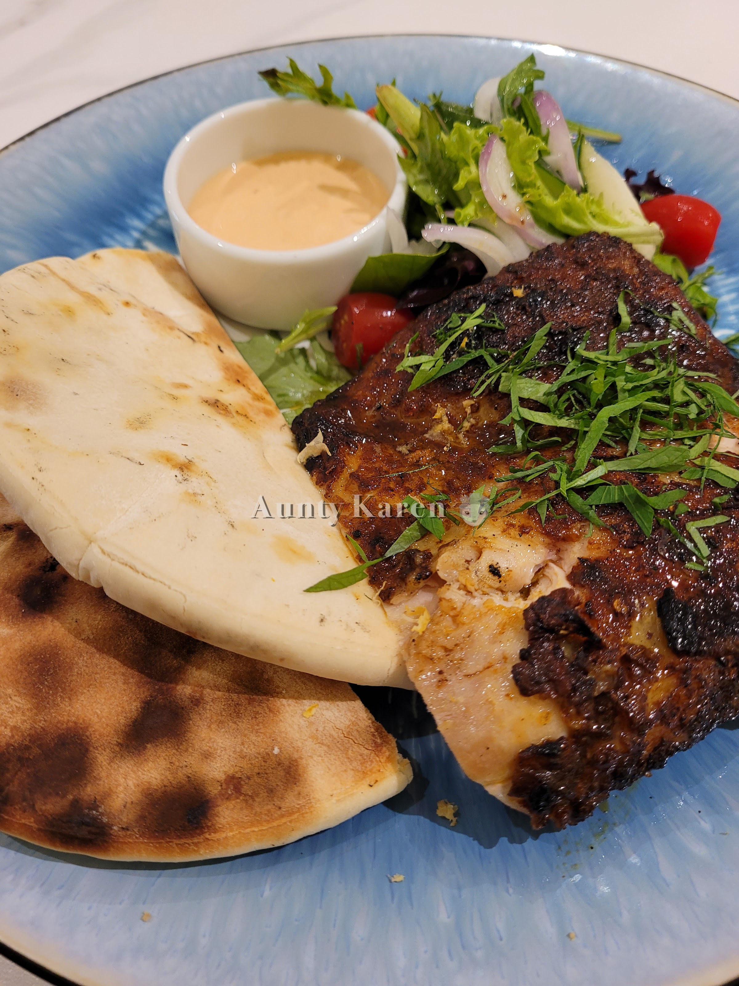 Close-up of Chicken Shawarma with pita bread, red onion, salad, and spicy yoghurt from White Marble at Orchard Rendezvous Hotel