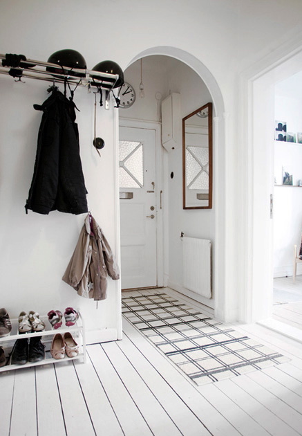 arch foyer entry hall entrance home house all white decor design wood floors shoe coat rack