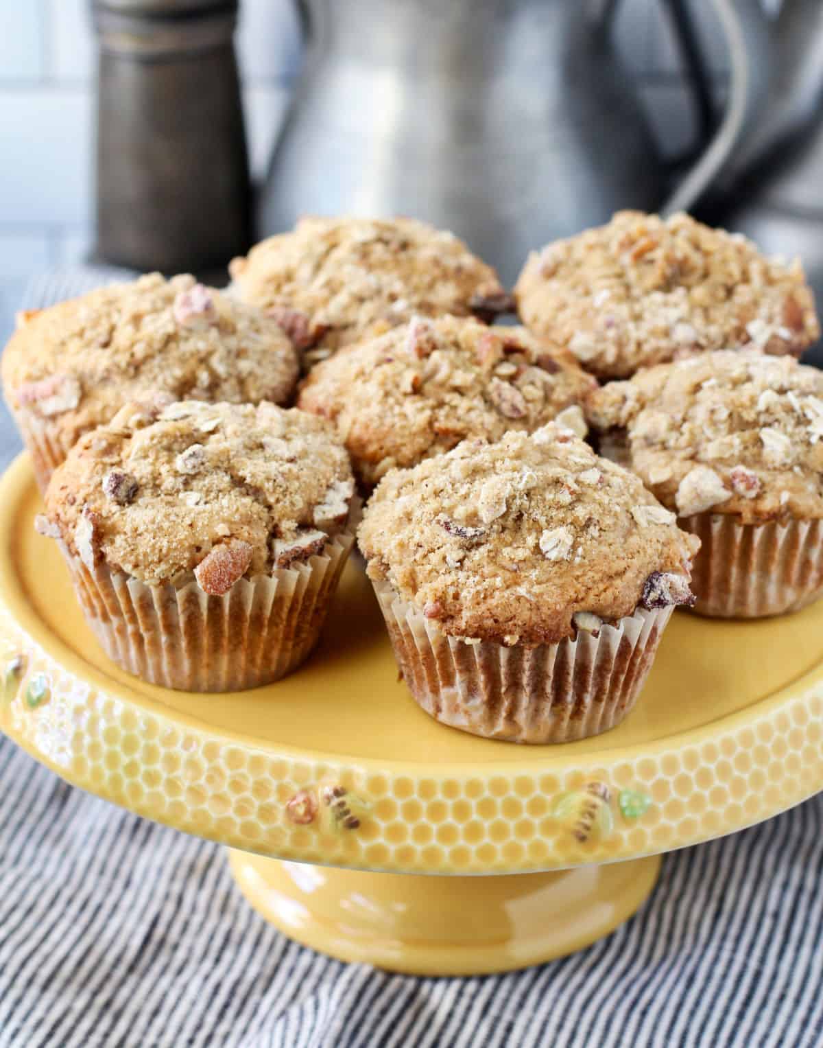 Sourdough Maple Pecan Muffins on a yellow cake pan.