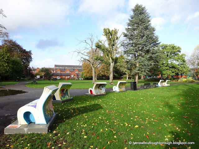 Benches commemorating Ladybird books in a horsehoe shape in a park setting