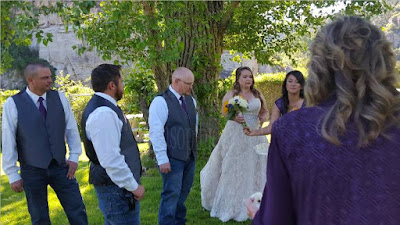 Randy and Dawns wedding party looking at the maid of honor spouting instructions