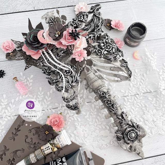 Altered plastic skeleton rib cage with Redesign with Prima moulds, Finnabair mixed media art mediums, and Prima Marketing flowers