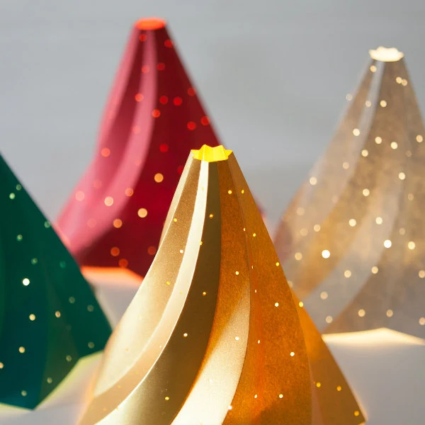 four examples of Twistmas Tree perforated paper luminaire sculptures