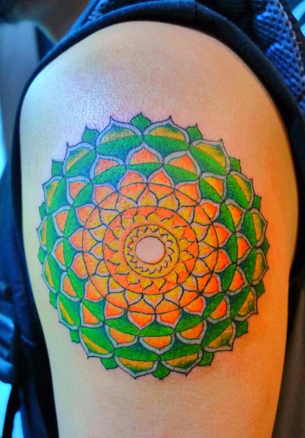 This is a beautiful, colorful mandala tattoo with rib designs