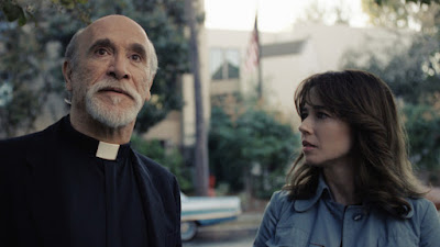 Dressed as a priest, Tony Amendola and Linda Cardellini discuss the La Llorona legend in The Conjuring Universe horror film The Curse of La Llorona