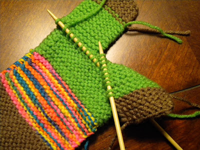 With your left needle, PU 1 st for each ridge on the front side of your knitting, on the leg opposite the tip your full needle, at the inside of the leg, starting at foot.