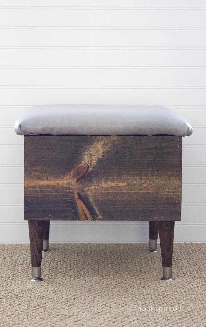 How to make an easy DIY wooden storage ottoman with a leather upholstered lid. #MonthlyDIYChallenge