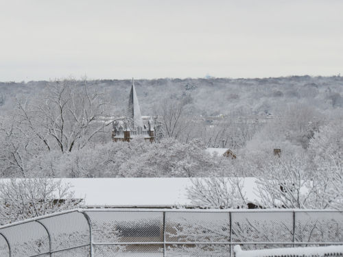 snow covered valley with church