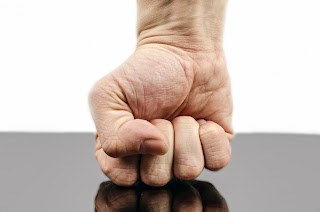 a photo of a male hand with its palm rounded into a fist