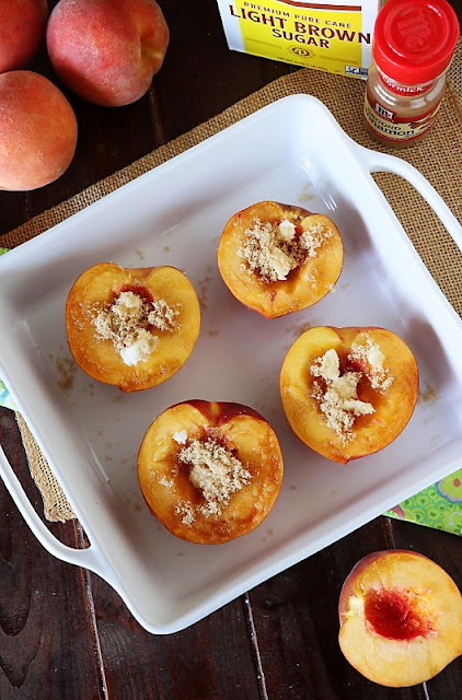 Fresh Peach Halves in Baking Dish Sprinkled with Brown Sugar and Butter Image