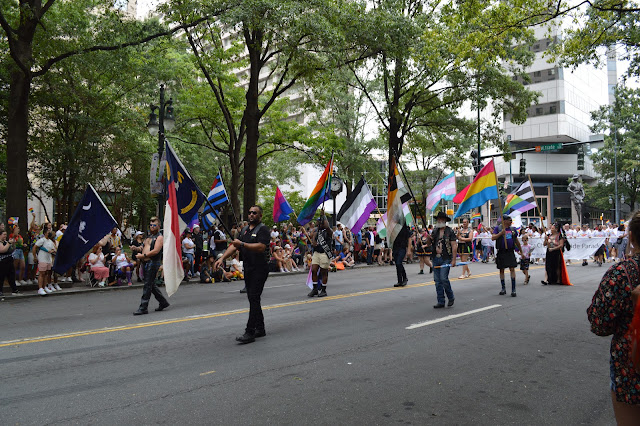 All of the different pride flags being carried by different people.