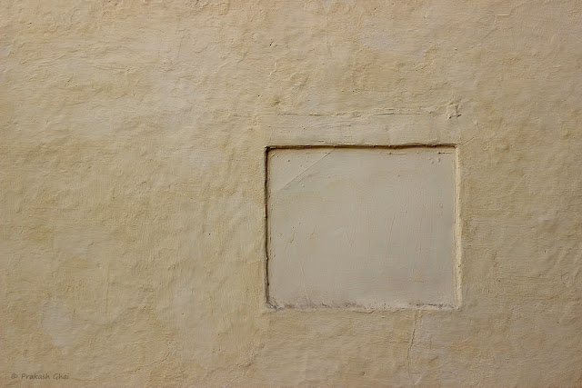 A Minimalist Photo of a Hollow Square on a Textured Brown Indian Wall.