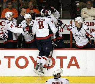 Washington Capitals' Alexander Ovechkin, of Russia, jumps into the arms of his teammates after scoring the first of his two goals in the third period of Game 6 of the Eastern Conference quarter final hockey playoffs with the Philadelphia Flyers, Monday, April 21, 2008, in Philadelphia. The Capitals won 4-2 tying the series 3-3. <br />(AP Photo/Tom Mihalek)