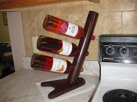 simple homemade wine rack, PVC pipe, wood, wine bottles