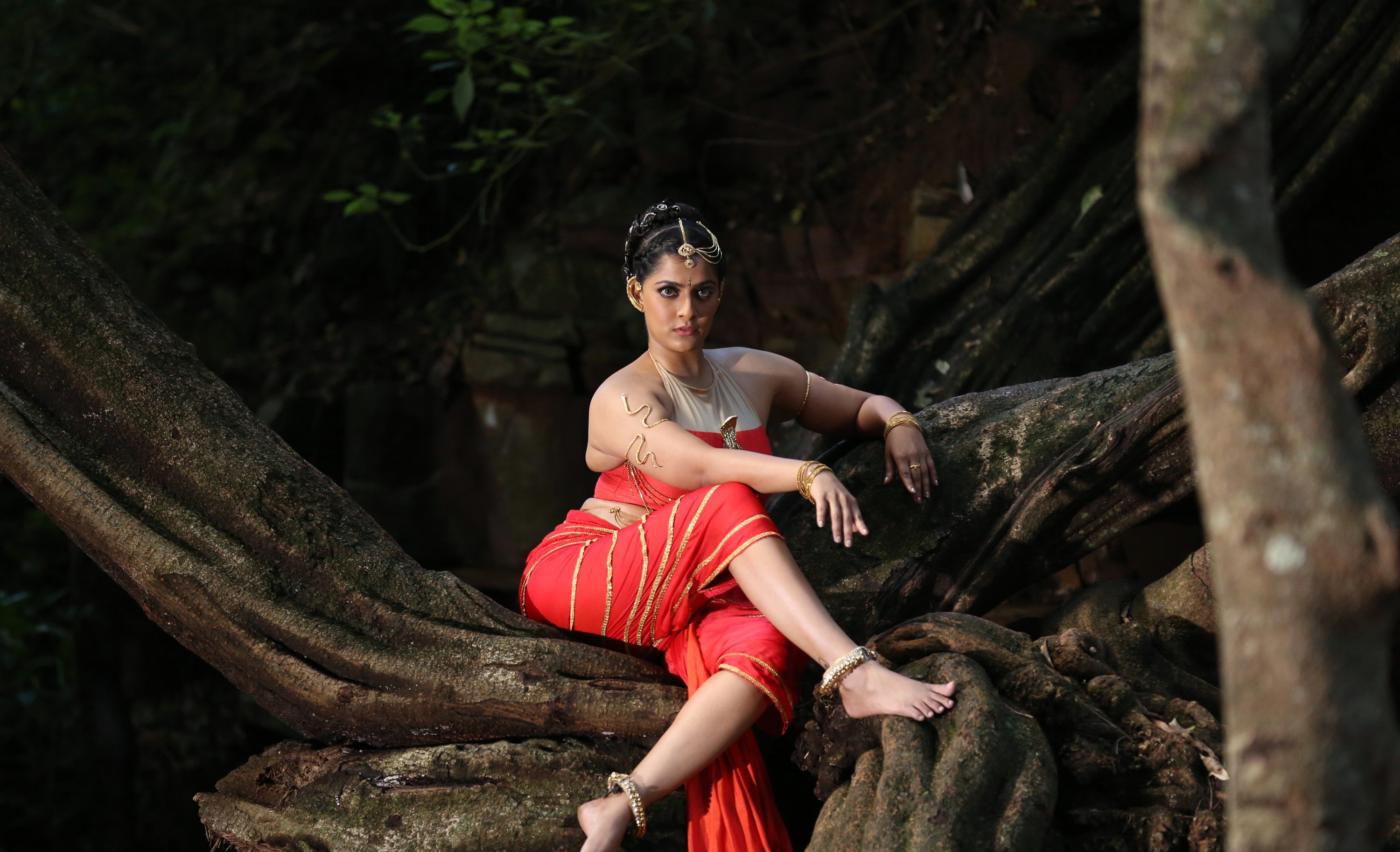 Actress Varalaxmi Hot Photoshoot in Orange Dress