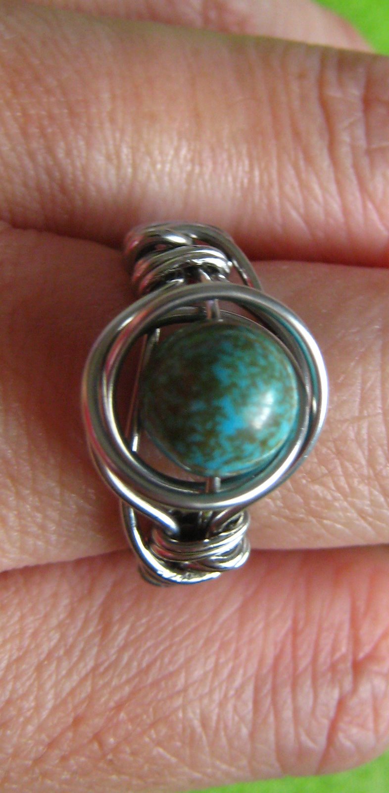 twice around the world (TAW) wire wrap ring on finger