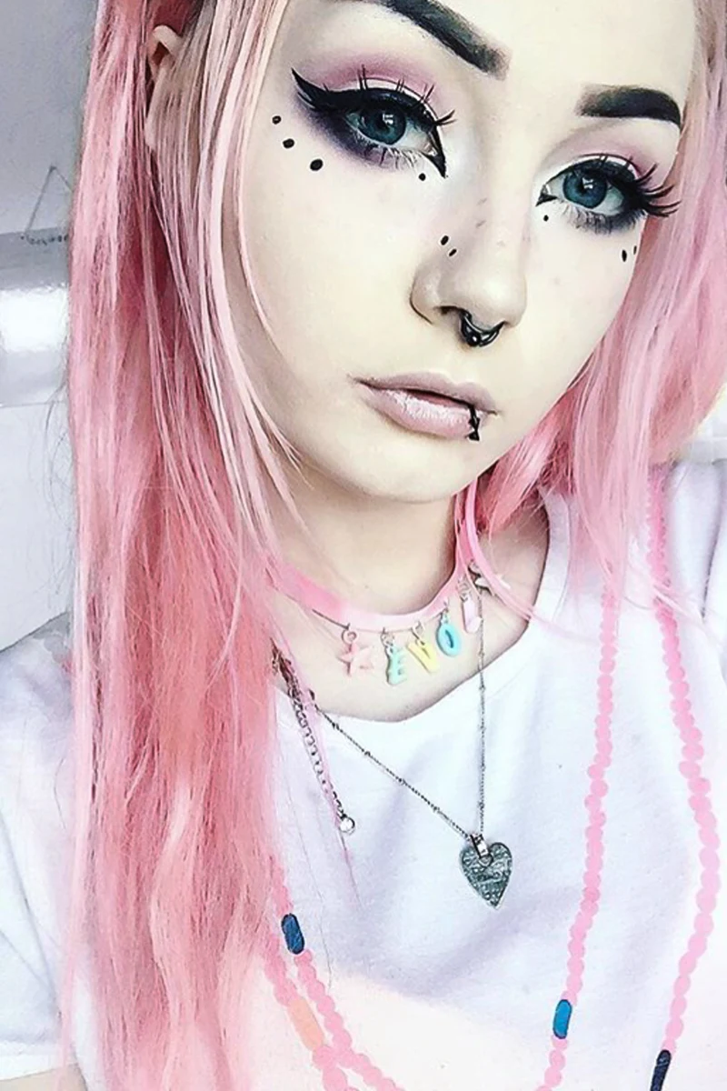 pretty selfie of a young woman with baby pink goth makeup look and thick eyeliner