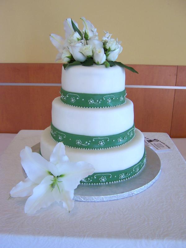 Simple and stunning four tier wedding cake in white with olive green satin