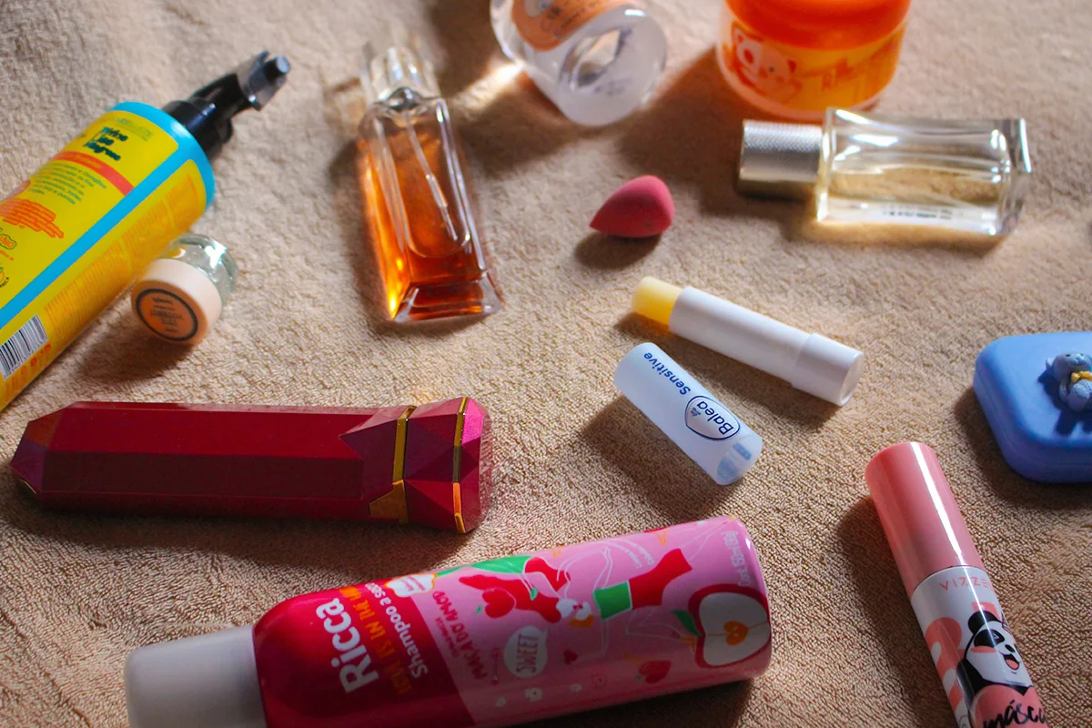 a bunch of different beauty products scattered on top of a cute fuxxy background