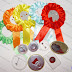 Textile Rosette, Available in Different Colors with round Pin Button Badges 44 or 58 mm. Avalibale color for rosettes: red, dark blue, orange, green, yellow, light blue, dark red, pink.