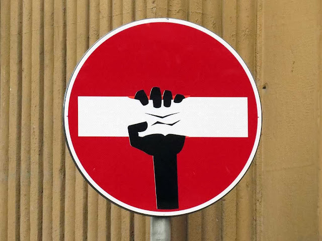 Squeezing the bar on a no-entry sign, Clet Abraham, Florence