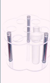 A Cirkul water bottle stored vertically in a transparent, flower-shaped acrylic organizer with metal supports.