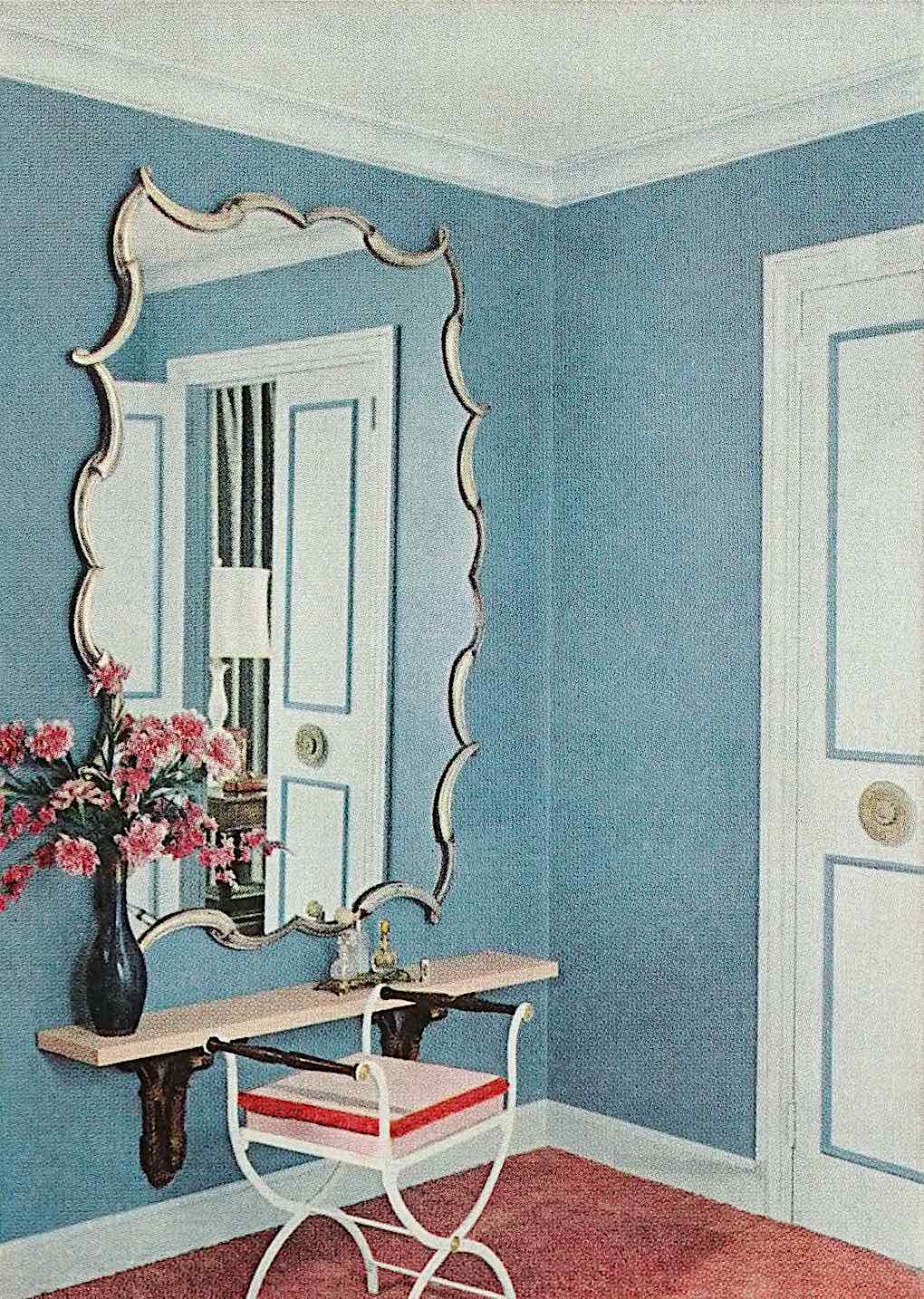 a 1959 home interior fancy mirror on a powder blue wall