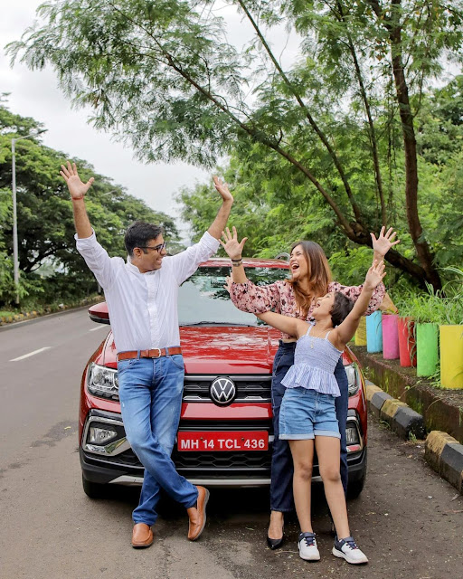 Family celebrating New Year with their new Volkswagen Taigun