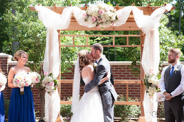 bride and groom first kiss at Noah's Event Venue in Auburn Hills Michigan