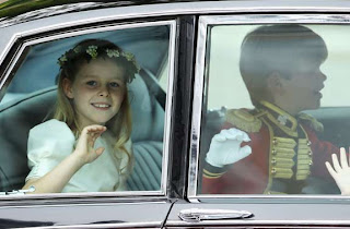 Bridesmaid Margarita Armstrong-Jones and page boy Tom Pettifer wave as they arrive to attend the Royal Wedding