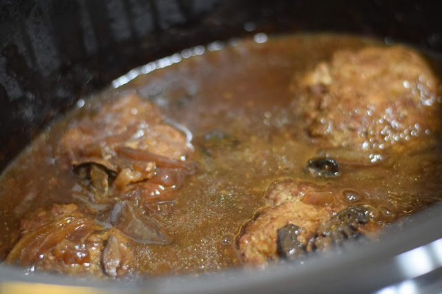 The salisbury steak patties have been returned to the gravy in the crockpot. 