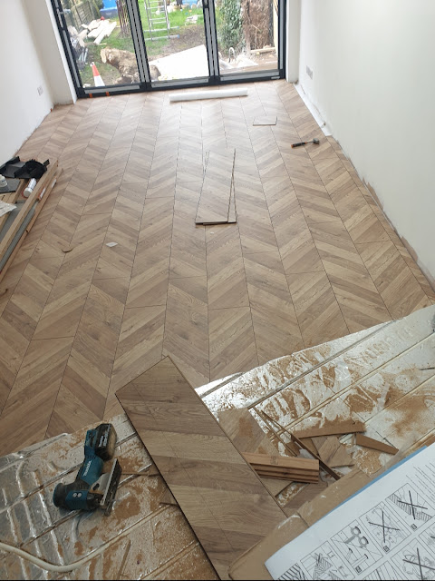 New chevron wooden flooring installation Victorian home renovation