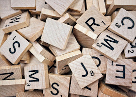 Scrabble tiles in pile, letters