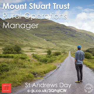 a person in sandals and a cap standing on a road stretching ahead towards mountains with a view of a river descending down a valley. Text reads: Mount Stuart Trust - Rural Operations Manager