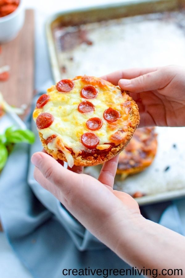 Child holding a mini pizza