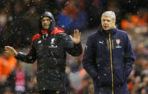 Bosses: Klopp and Wenger look on at Anfield
